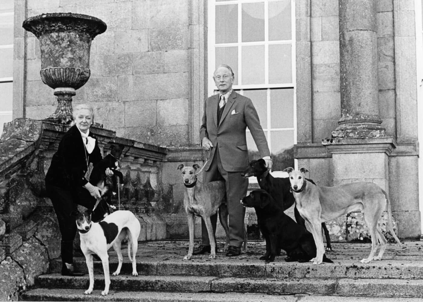 Sir Alfred and Lady Clemetine Beit on Russborough steps with dogs