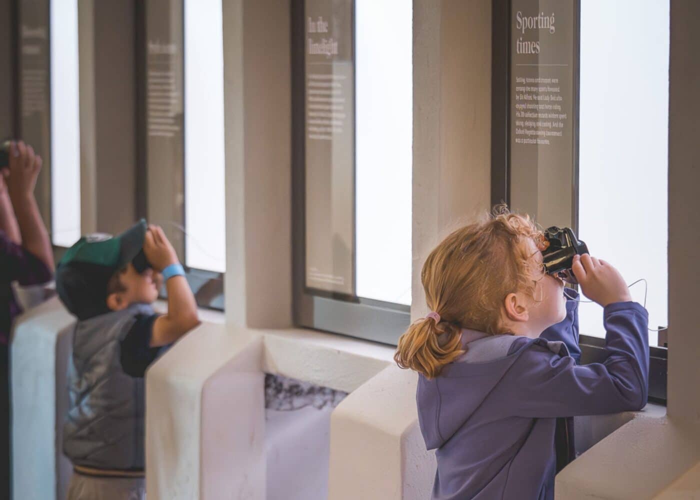 children looking at photos in the Beit Museum