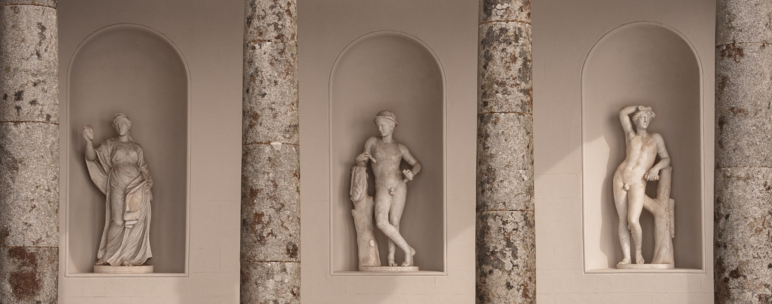 sculpted statues in a colonnade